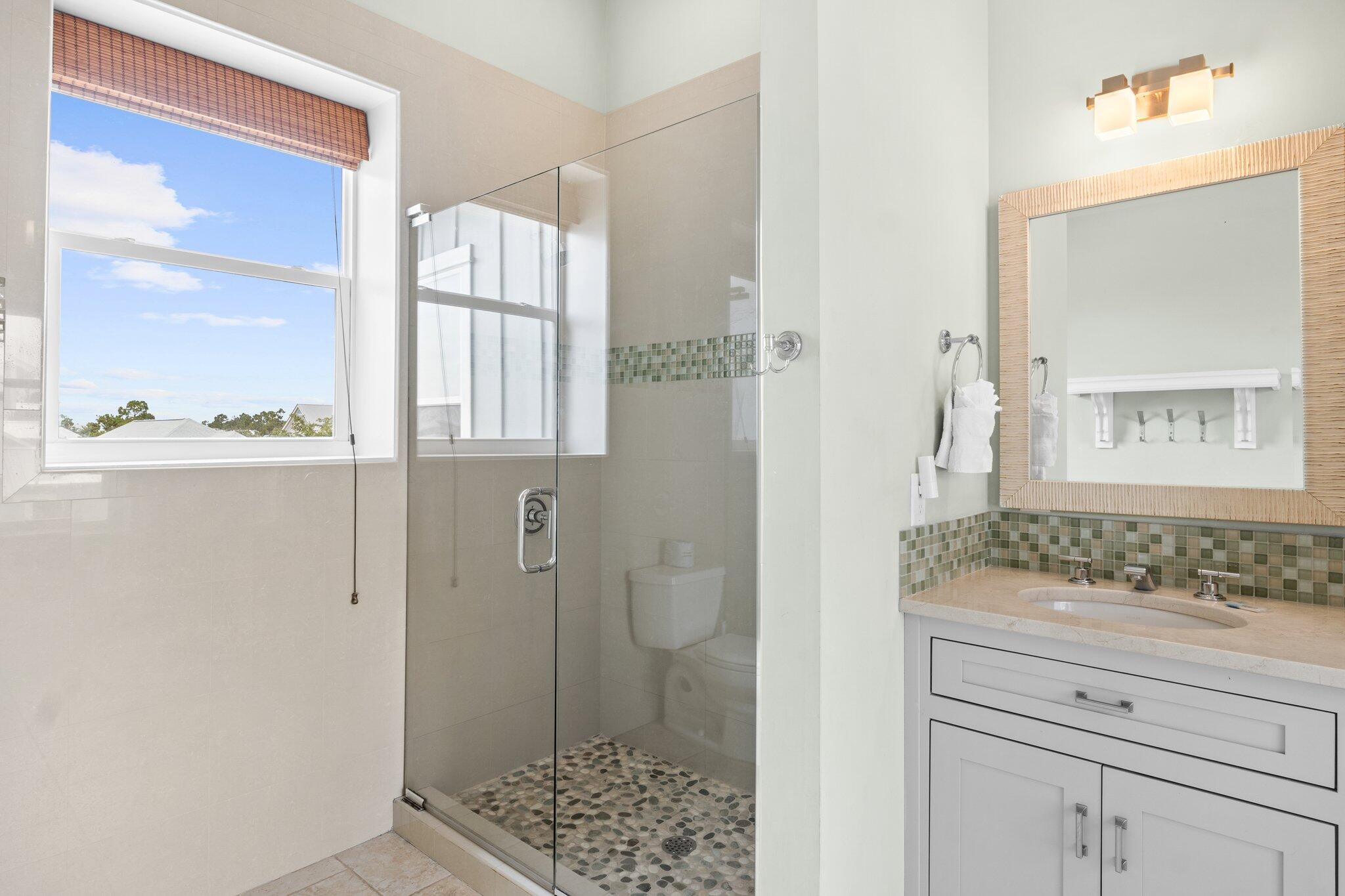 104 Pinwheel Court Port St. Joe, FL 32456 - Photo 87 of 119 a bathroom with a granite countertop sink mirror and shower