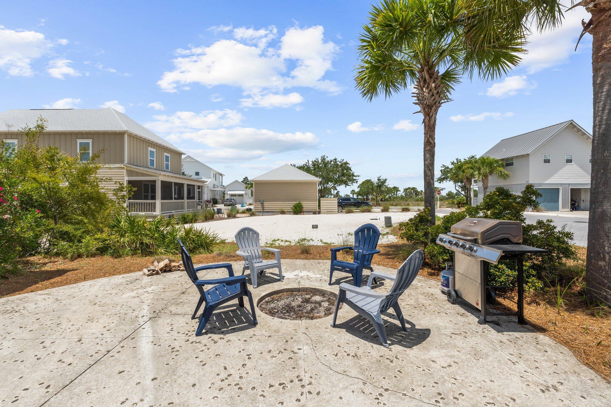 104 Pinwheel Court Port St. Joe, FL 32456 - Photo 9 of 119 a view of a patio with a dining table and chairs with wooden fence