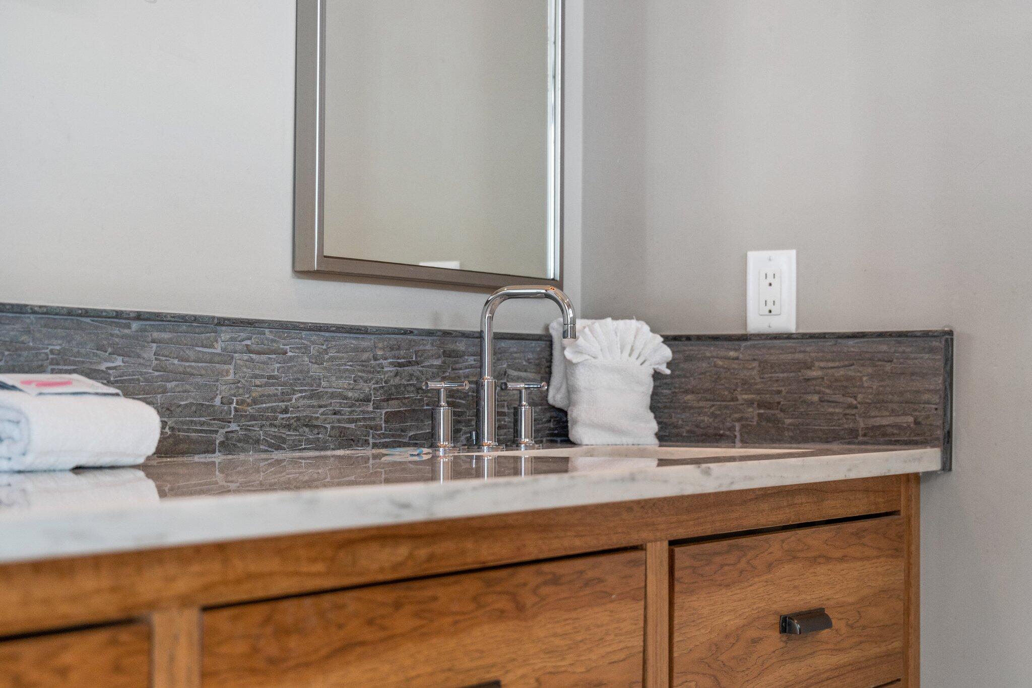 104 Pinwheel Court Port St. Joe, FL 32456 - Photo 96 of 119 a bathroom with a granite countertop sink and a mirror