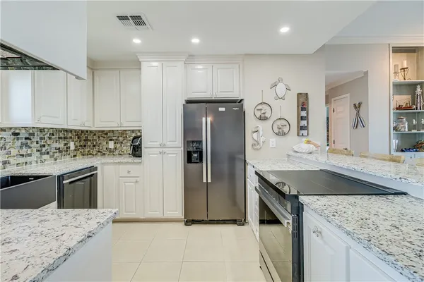 a kitchen with stainless steel appliances granite countertop a stove and a sink