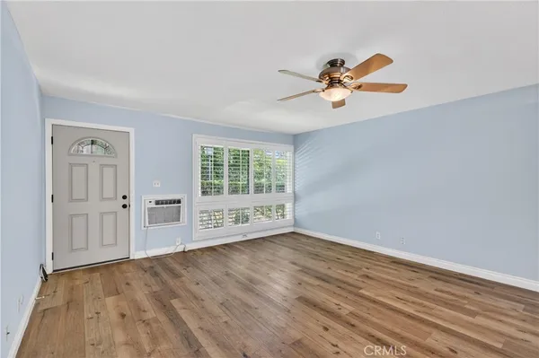 wooden floor in an empty room with a window