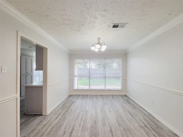 a kitchen with a sink cabinets and wooden floor