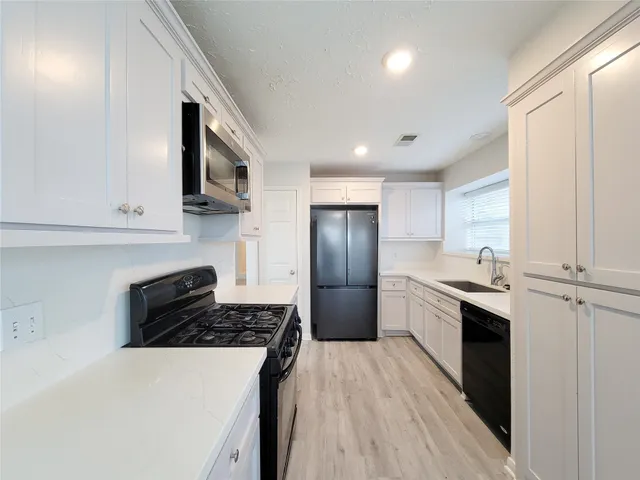 a kitchen with a refrigerator and a sink