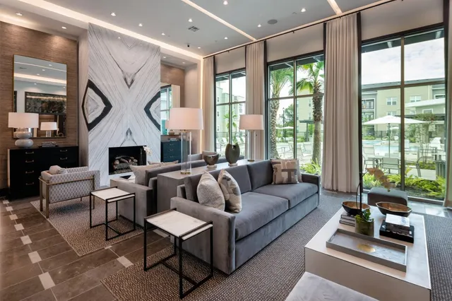 a lobby with furniture and floor to ceiling window