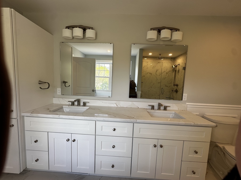 56 Dudley Road Billerica, MA 01821 - Photo 23 of 29 a bathroom with a double vanity sink and mirror