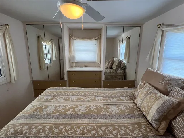 a living room with a bed and a mirror