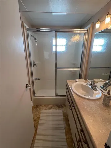 a bathroom with a sink and mirror