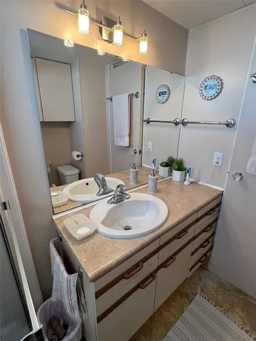 a bath room with a sink and a mirror