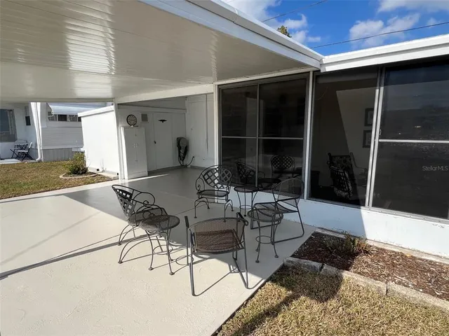 a view of a patio with table and chairs and potted plants