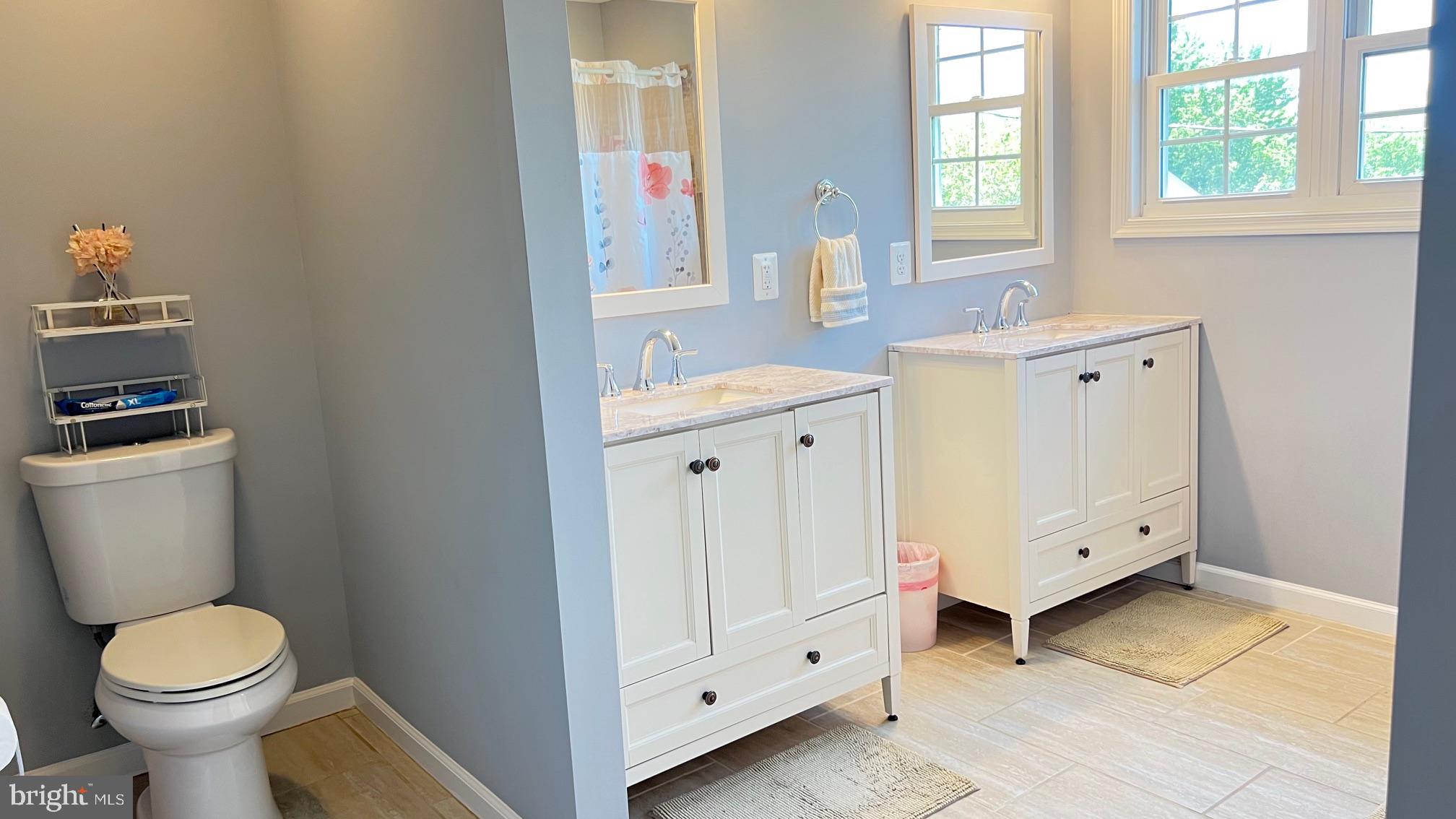 811 223rd Street Pasadena, MD 21122 - Photo 24 of 31 a bathroom with a toilet sink and mirror