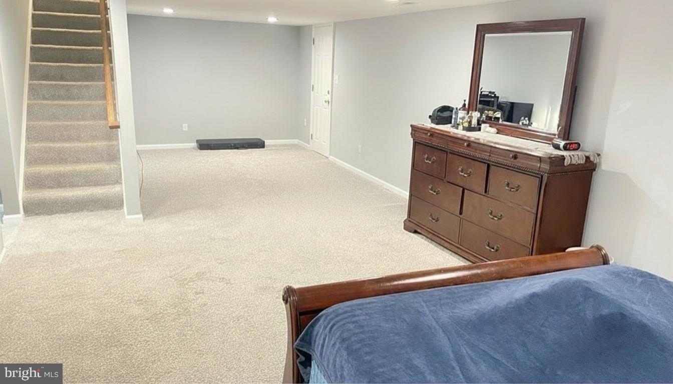 811 223rd Street Pasadena, MD 21122 - Photo 29 of 31 a bedroom with a bed and a mirror on the dresser