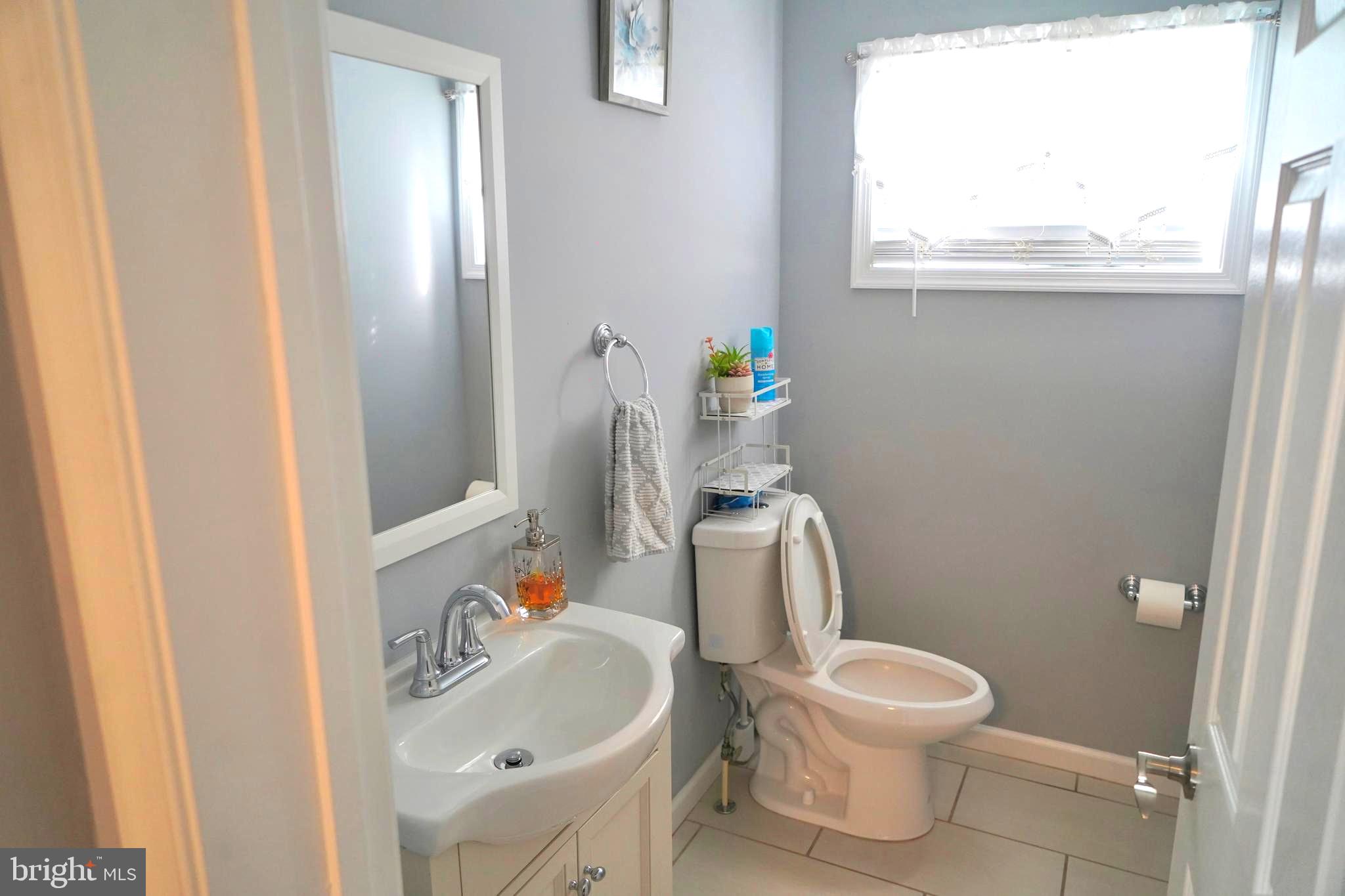 811 223rd Street Pasadena, MD 21122 - Photo 5 of 31 a white toilet sitting next to a bathroom sink