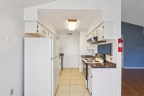 a kitchen with stainless steel appliances a refrigerator and a stove