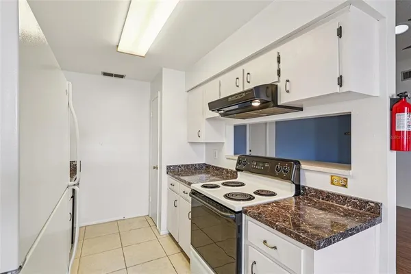a kitchen with a stove and a refrigerator