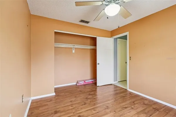 a view of a room with wooden floor and chandelier