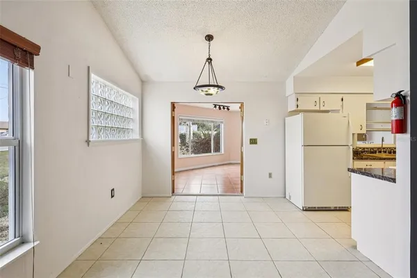 a kitchen with refrigerator and window