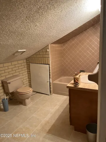 a view of a small space with wooden floor and a window