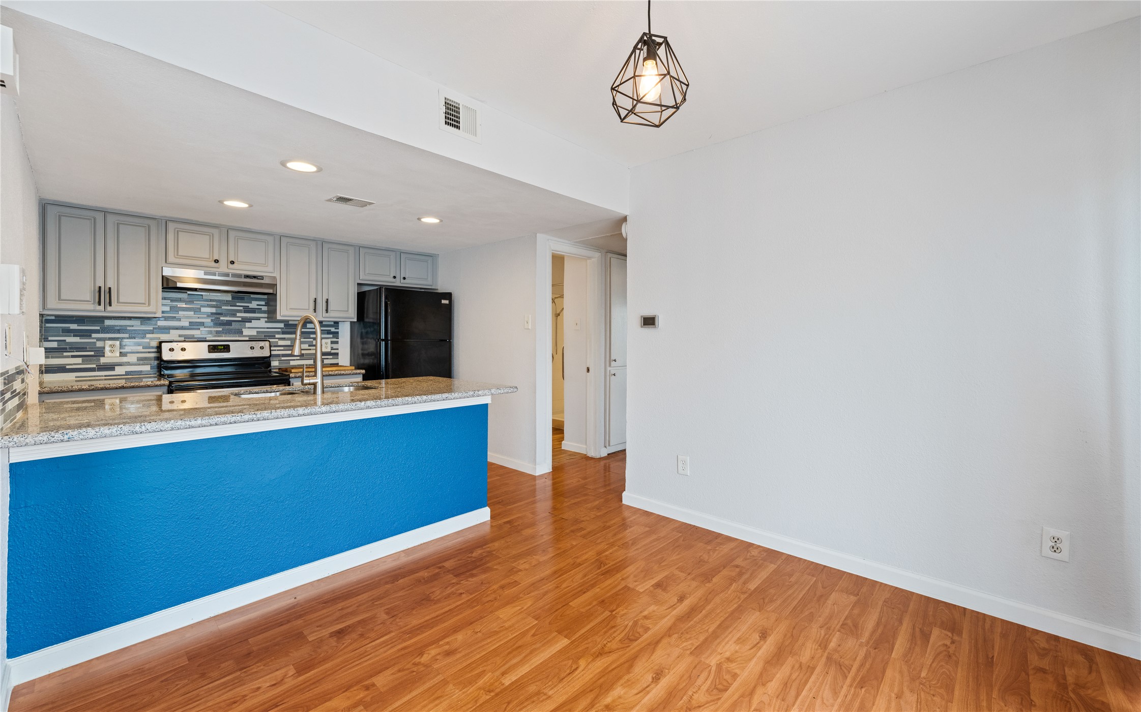 2124 Burton Drive, Unit 159 Austin, TX 78741 - Photo 8 of 23 A well-appointed kitchen features ample counter space, modern appliances, and a seamless flow into an adjacent dining area.