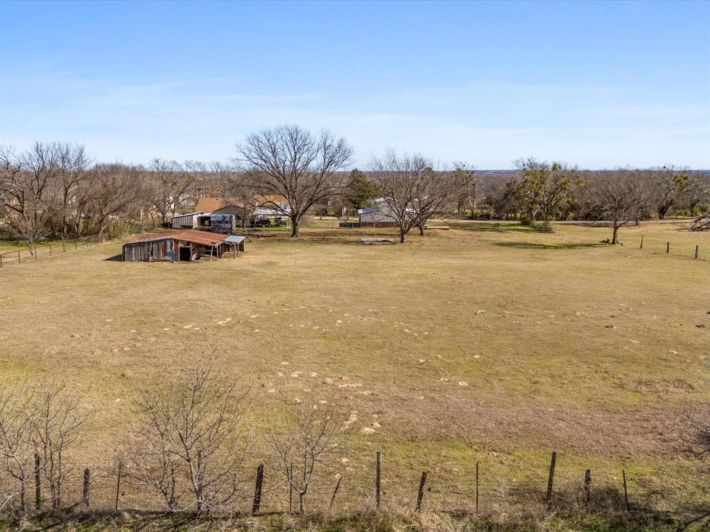 Tbd South Ewing Street Boyd, TX 76023 - Photo 24 of 24 Expansive property featuring a large open field, perimeter fencing, and mature trees