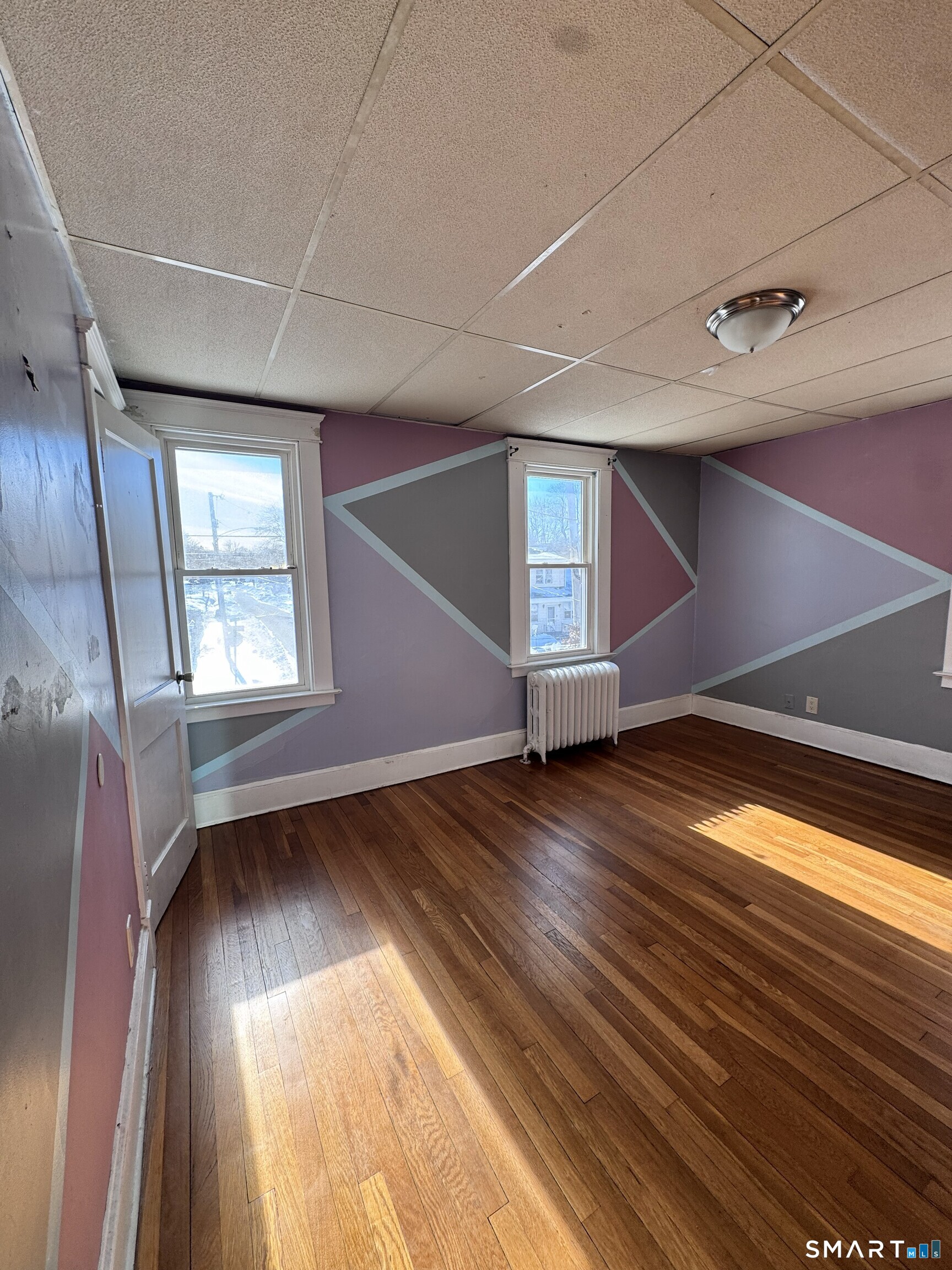 269 Helen Street Hamden, CT 06514 - Photo 12 of 16 a view of an empty room with wooden floor and a window