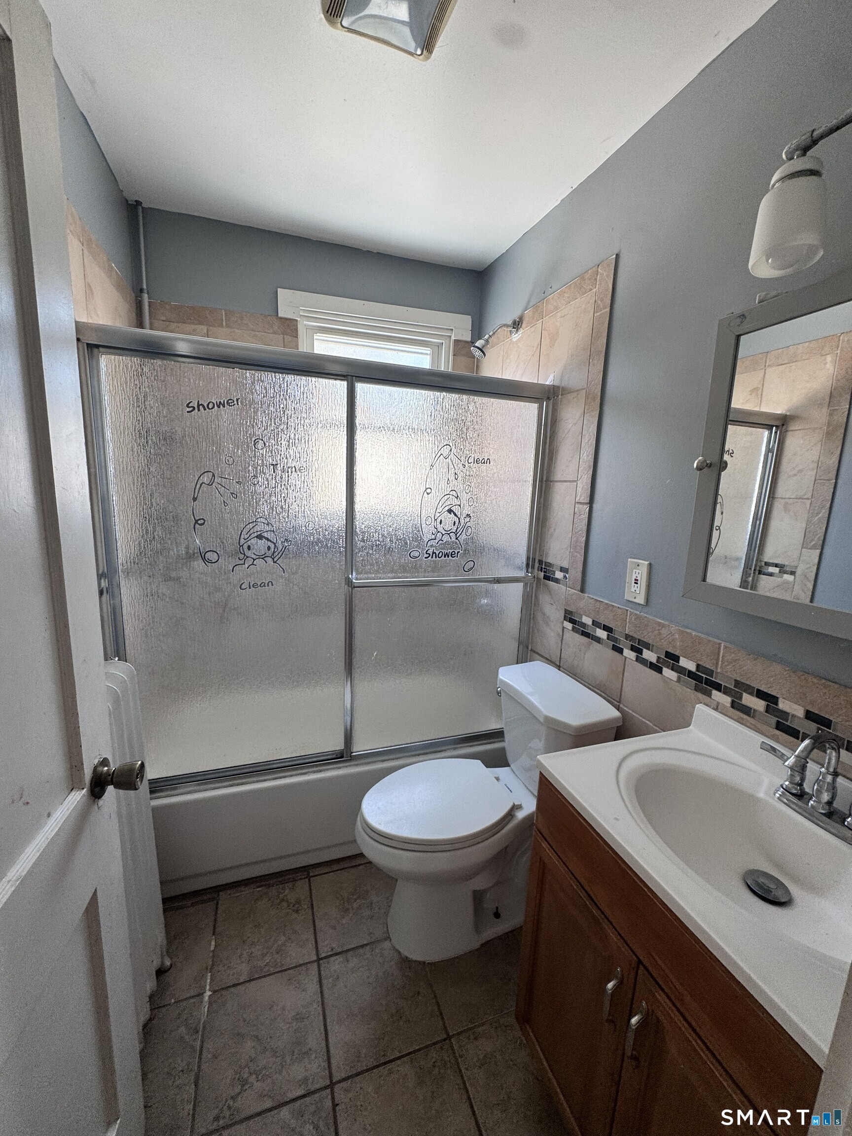 269 Helen Street Hamden, CT 06514 - Photo 15 of 16 a bathroom with a toilet sink and mirror