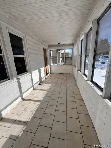 a view of an entryway with wooden floor