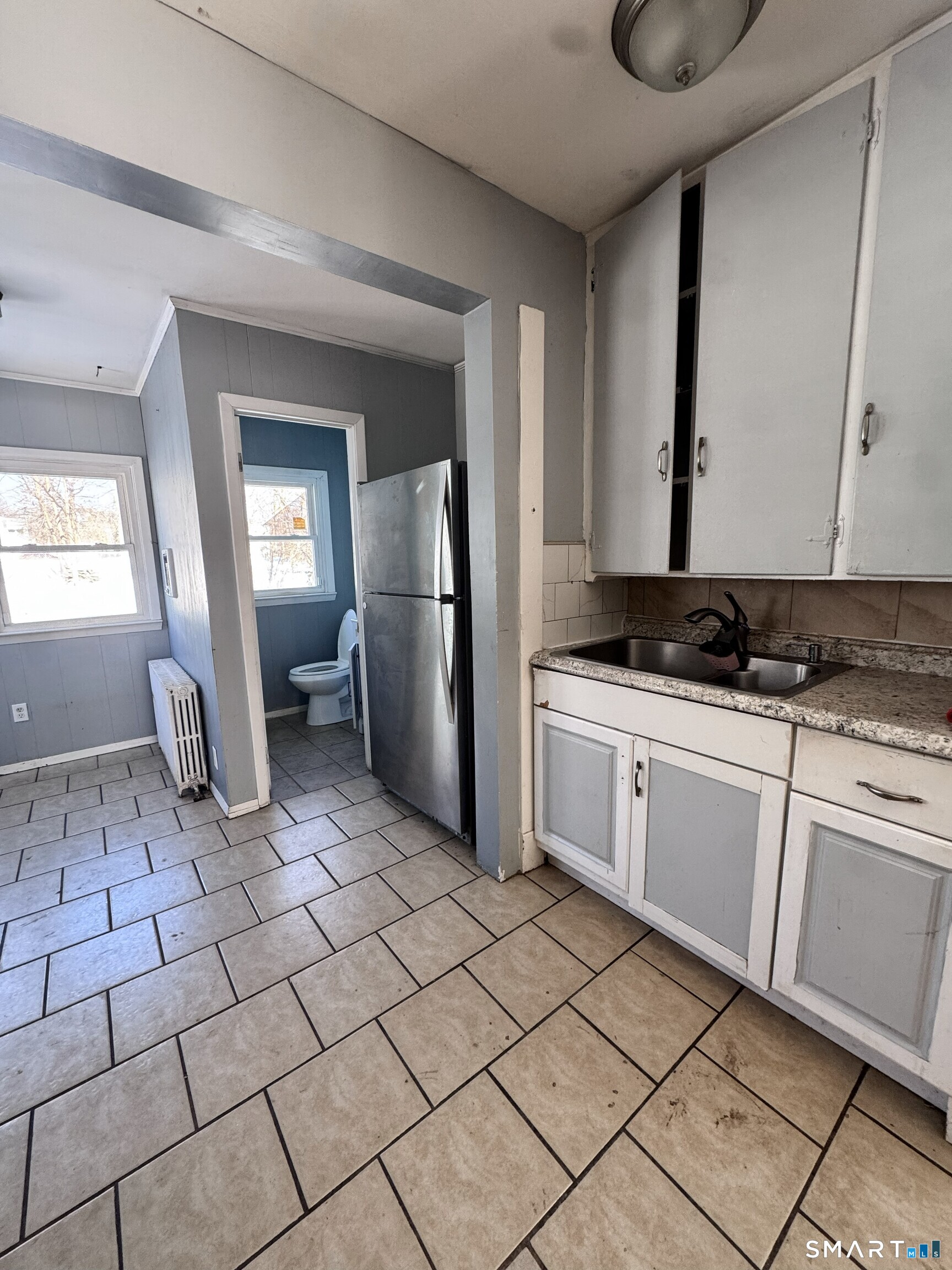 269 Helen Street Hamden, CT 06514 - Photo 8 of 16 a kitchen with a refrigerator a stove a sink and a window