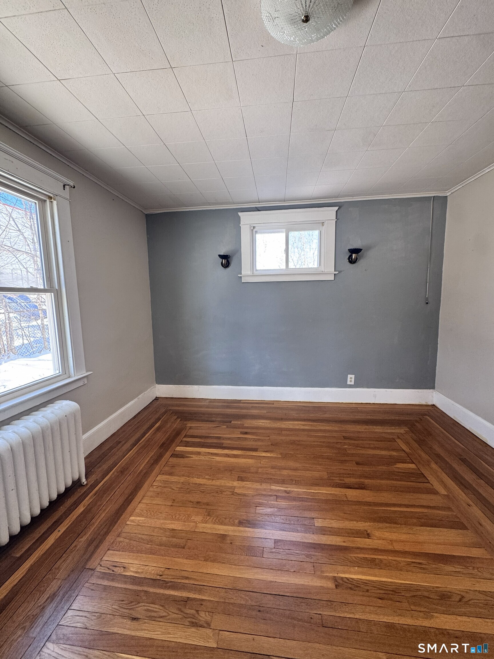 269 Helen Street Hamden, CT 06514 - Photo 9 of 16 a view of an empty room with wooden floor and a window