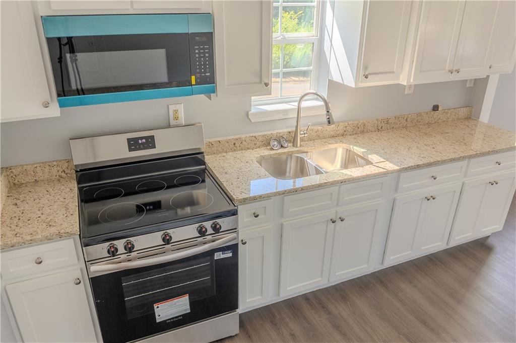 53 Washington Drive Forsyth, GA 31029 - Photo 8 of 19 a kitchen with a sink stove and cabinets