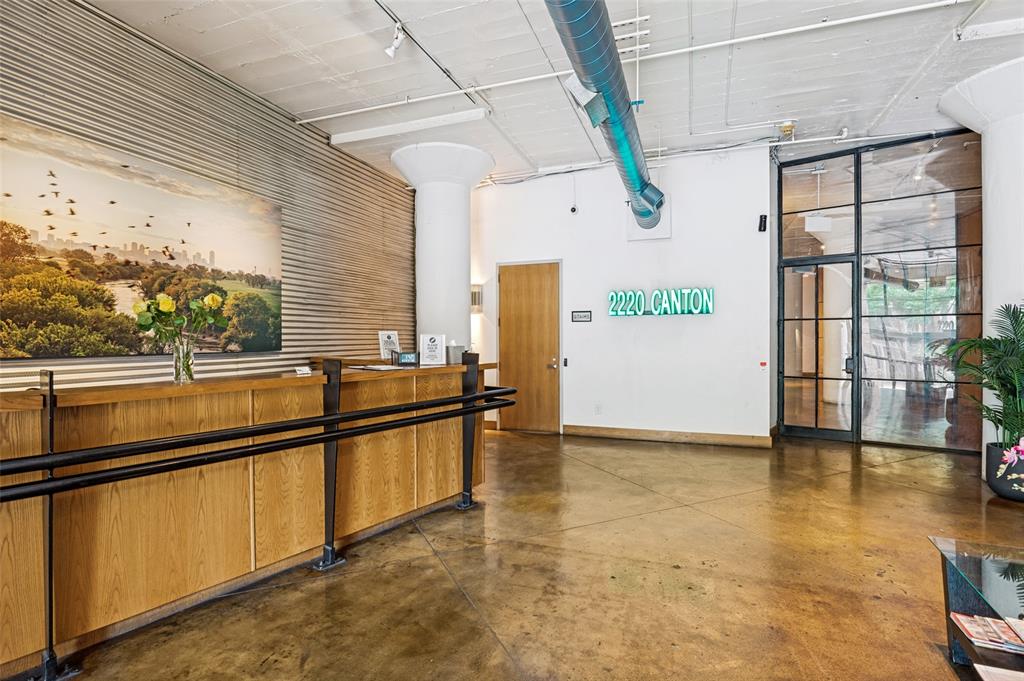 2220 Canton Street, Unit 101 Dallas, TX 75201 - Photo 11 of 20 Lobby area featuring polished concrete flooring, exposed overhead ductwork, and a wooden reception desk with black metal railing