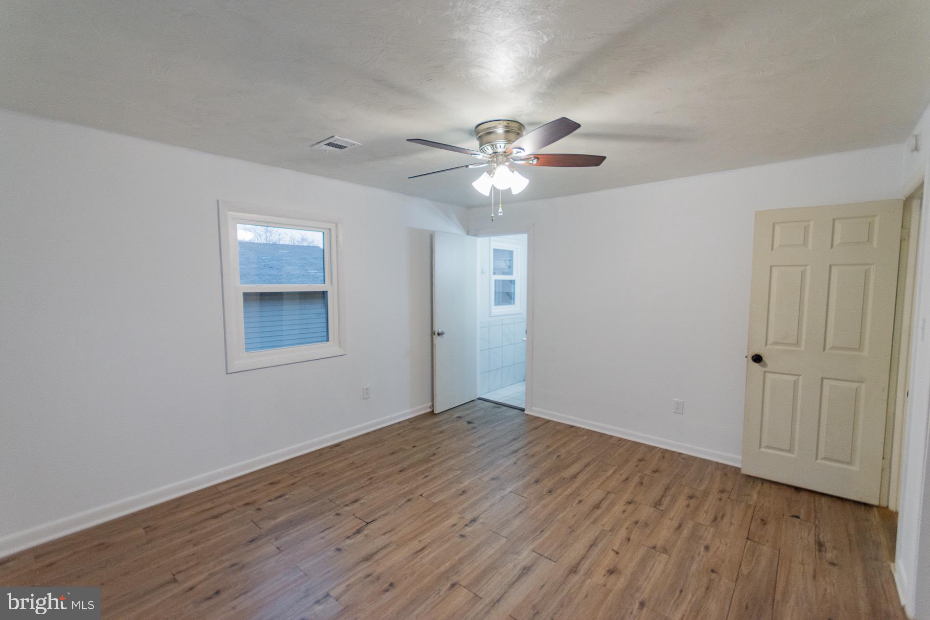 602 North Reymann Street Ranson, WV 25438 - Photo 20 of 44 a view of an empty room with a window and wooden floor