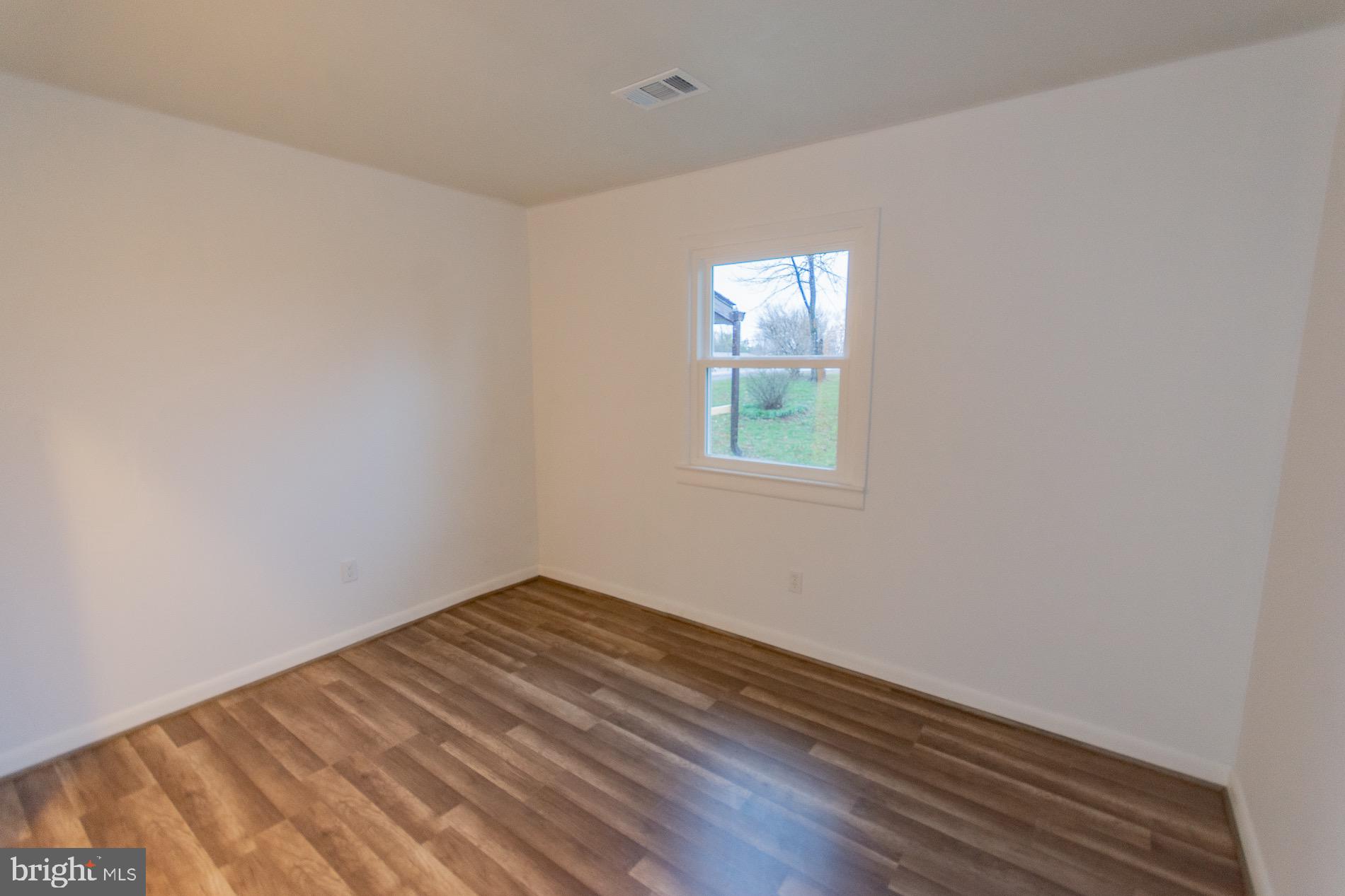 602 North Reymann Street Ranson, WV 25438 - Photo 28 of 44 a view of an empty room with wooden floor and a window