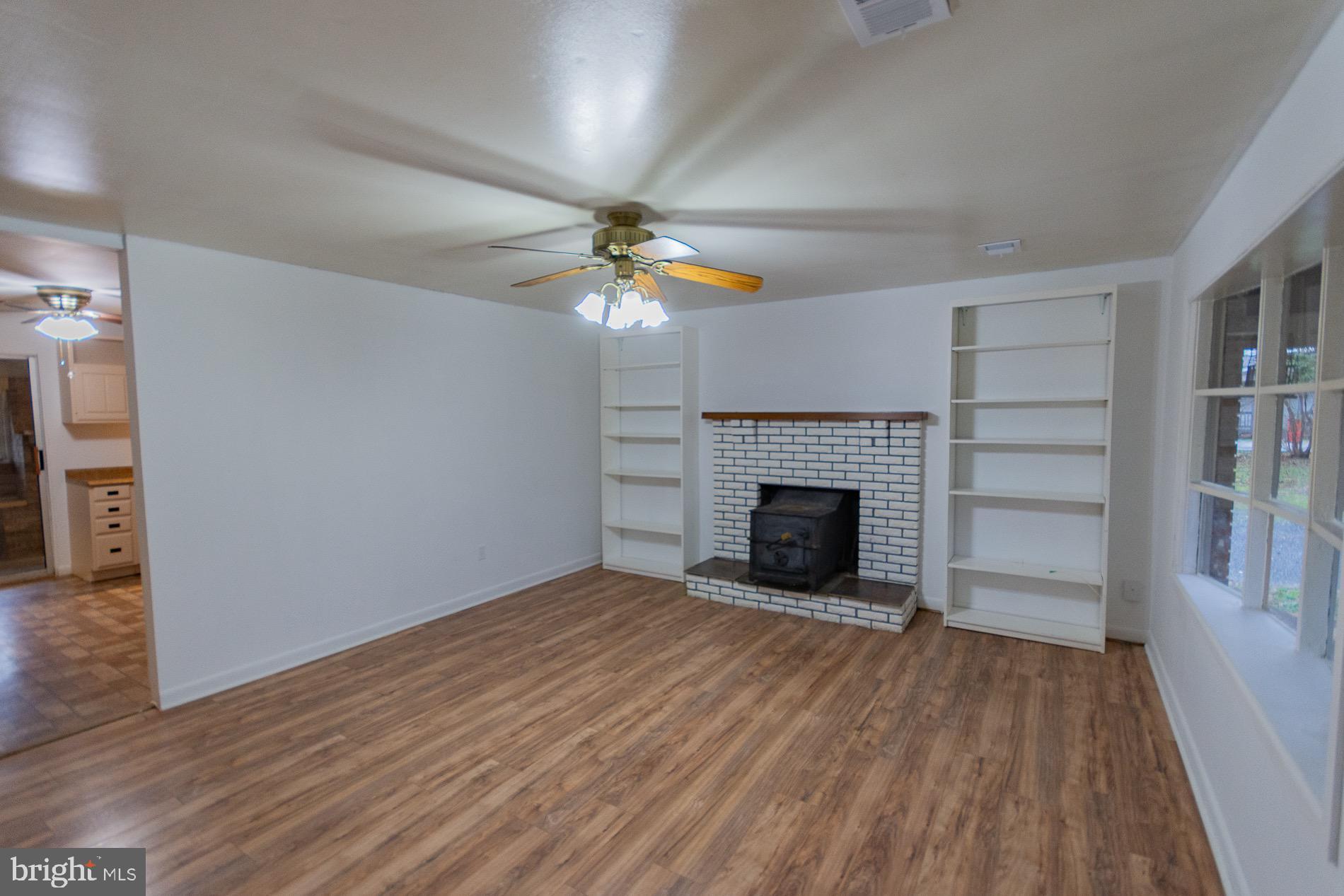 602 North Reymann Street Ranson, WV 25438 - Photo 3 of 44 wooden floor fireplace and windows in an empty room