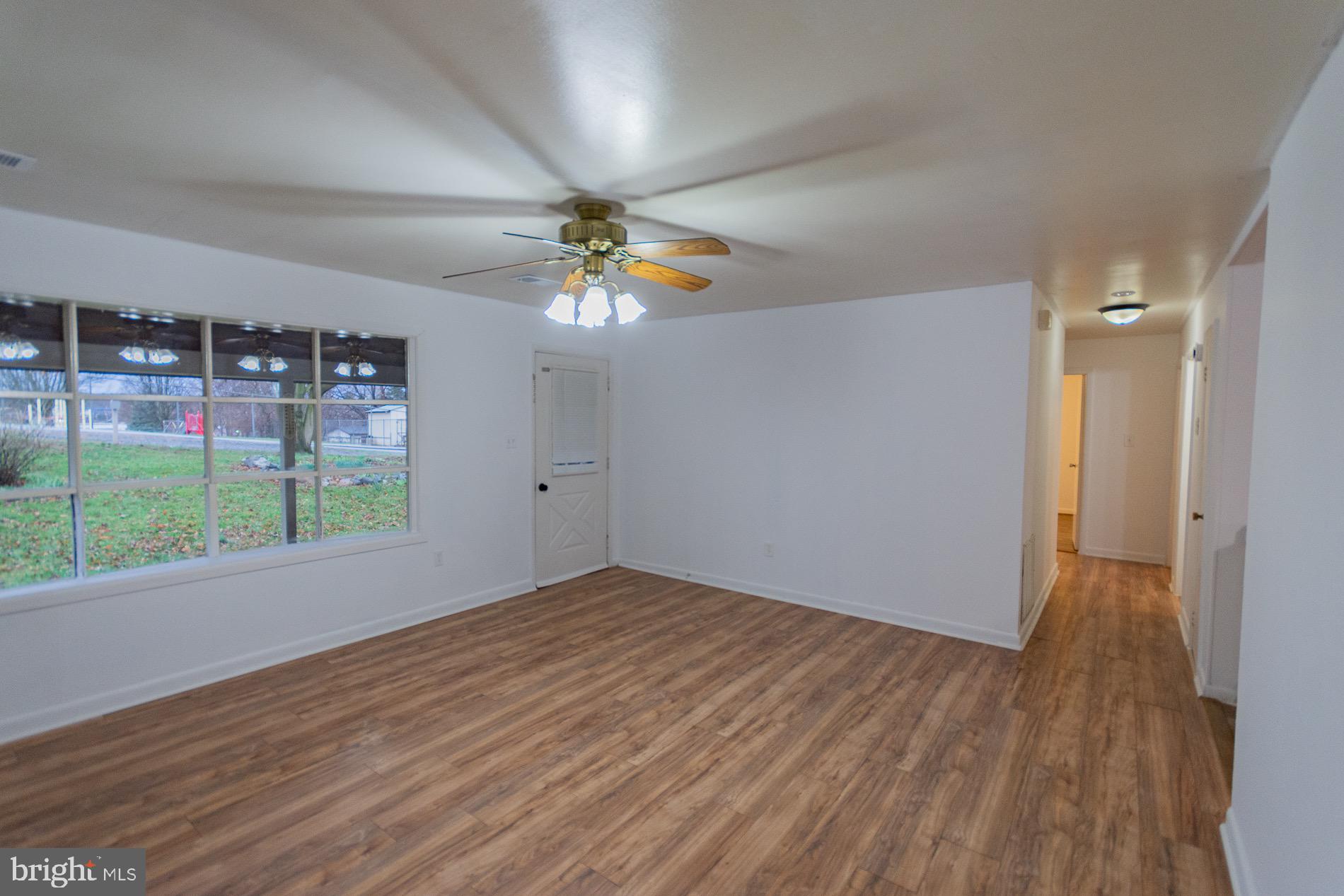 602 North Reymann Street Ranson, WV 25438 - Photo 5 of 44 a view of an empty room with glass door and wooden floor