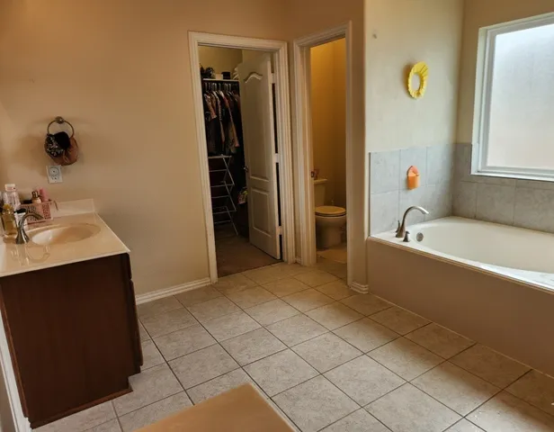 a bathroom with a tub and shower