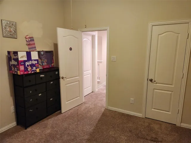 a bedroom with a bed tv and a window