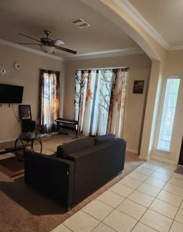 a living room with furniture and a window