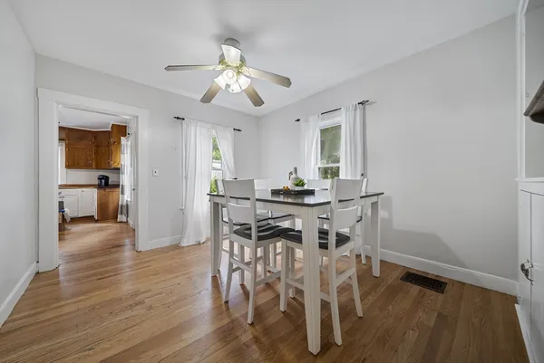 a view of a dining room with furniture and wooden floor