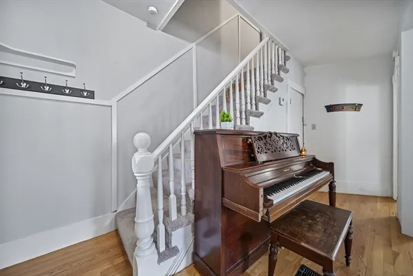 a view of entryway and hall with wooden floor