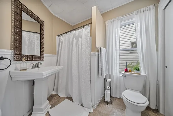 a white toilet sitting next to a bathroom sink