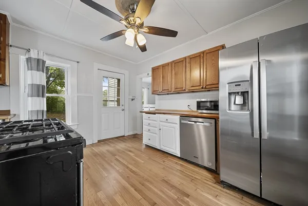 a kitchen with stove cabinets and refrigerator