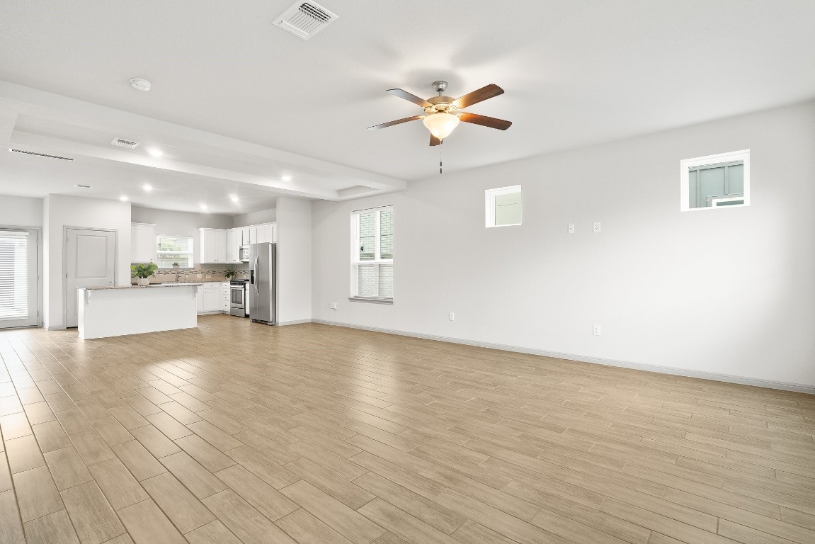 5913 B Charles Merle Dr., Unit 16 Austin, TX 78747 - Photo 12 of 35 a view of a kitchen with wooden floor and a kitchen space