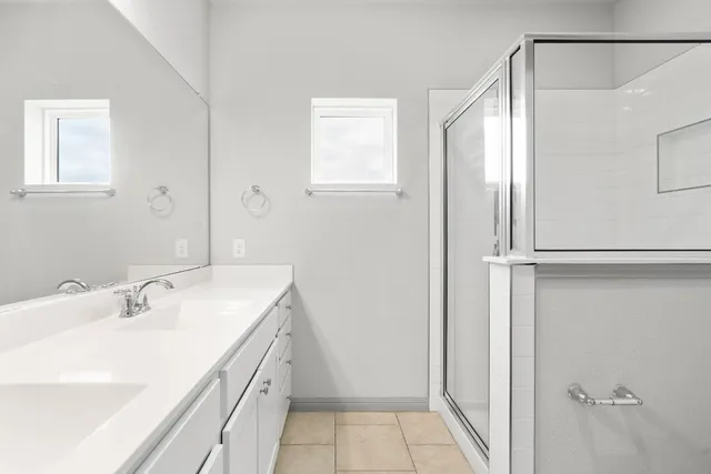 a bathroom with a double vanity sink and a mirror