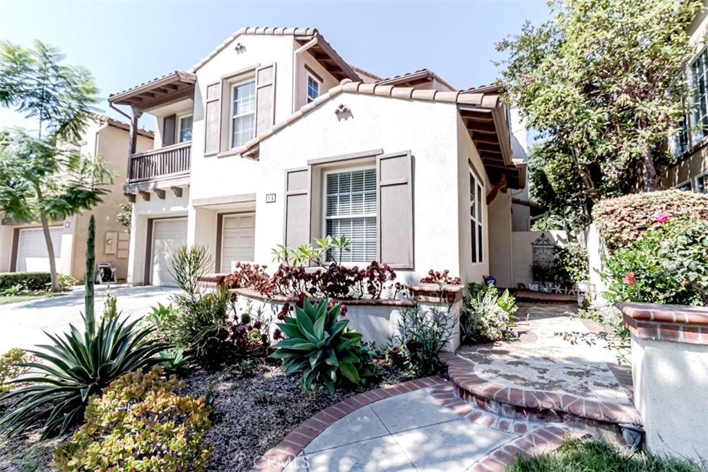 a front view of house with yard and trees around