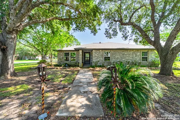 a view of a house with backyard sitting area and garden