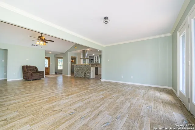 a living room with a couch and chandelier