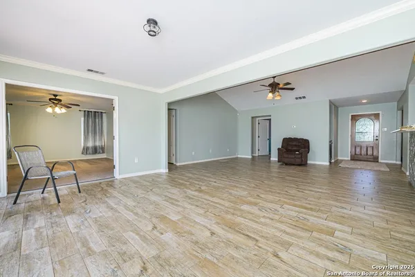 a view of empty room with window wooden floor and front door