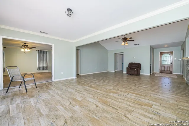a view of empty room with window wooden floor and front door