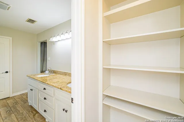 a bathroom with a granite countertop sink a shower and a mirror