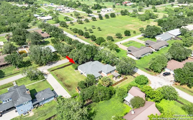 an empty room with ceiling fan and window